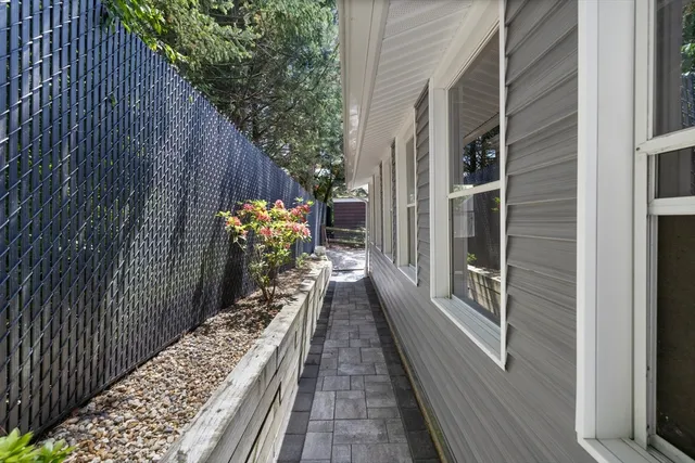 a view of a patio with furniture and table under an umbrella
