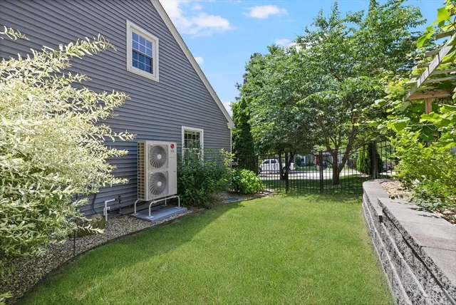 a view of backyard of house with a patio and a garden