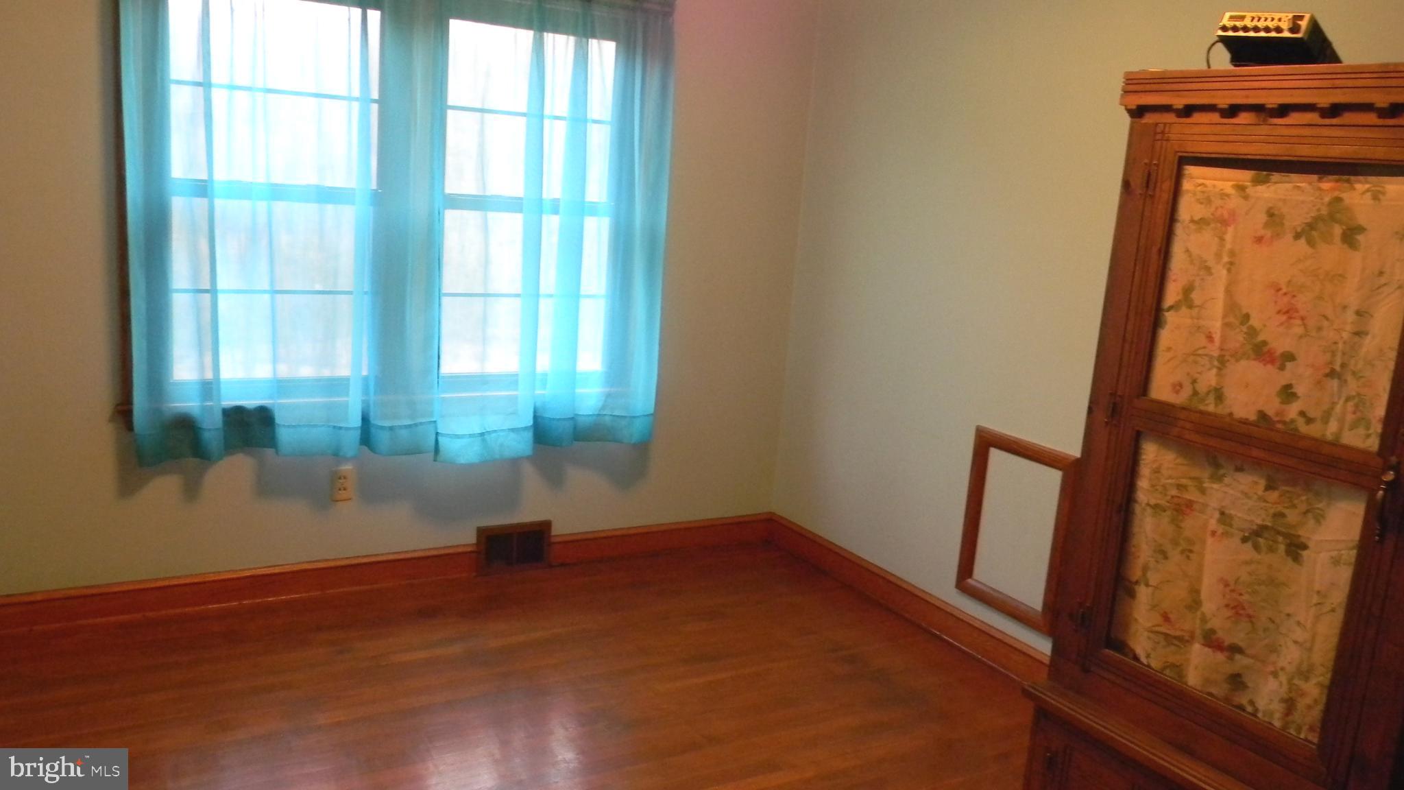 6688 Brocks Gap Road Broadway, VA 22815 - Photo 44 of 81 an empty room with wooden floor and windows
