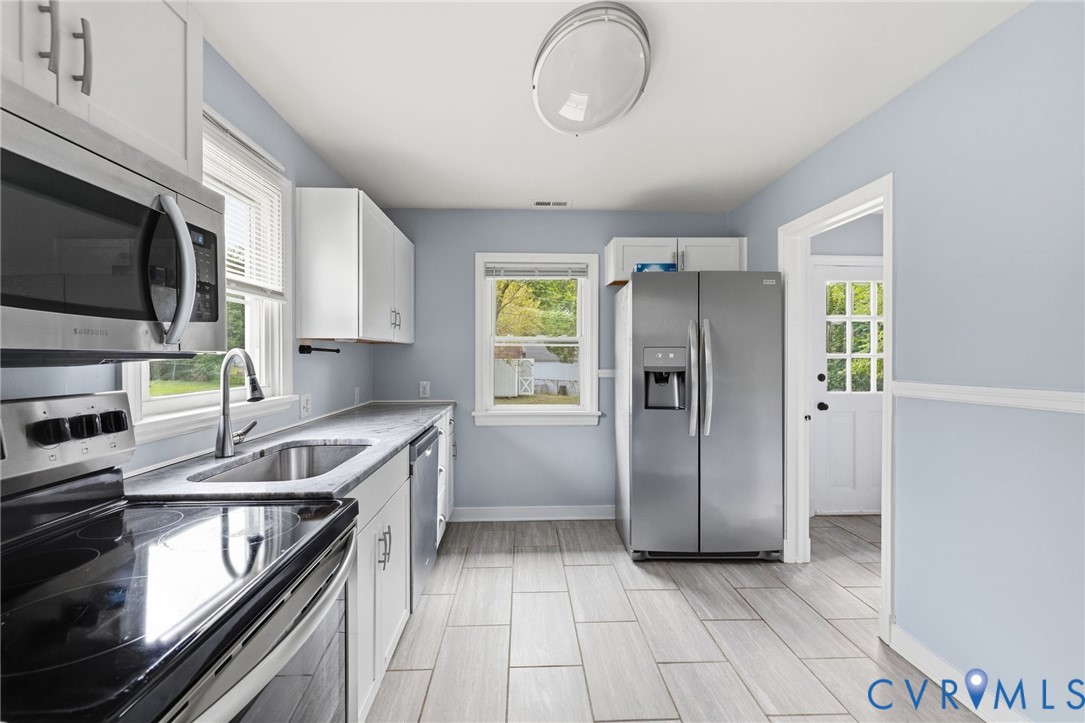 5901 Bonneau Road Richmond, VA 23227 - Photo 8 of 21 Updated kitchen featuring white shaker-style cabin
