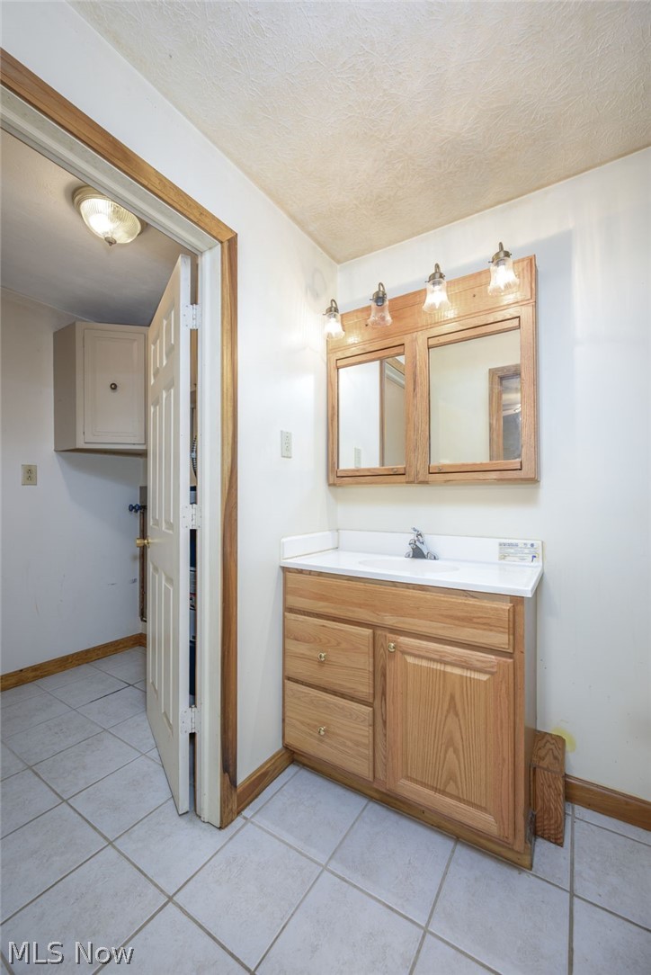 6503 Garrett Road Ravenna, OH 44266 - Photo 16 of 50 Wood-finish vanity with an integrated sink and chrome faucet