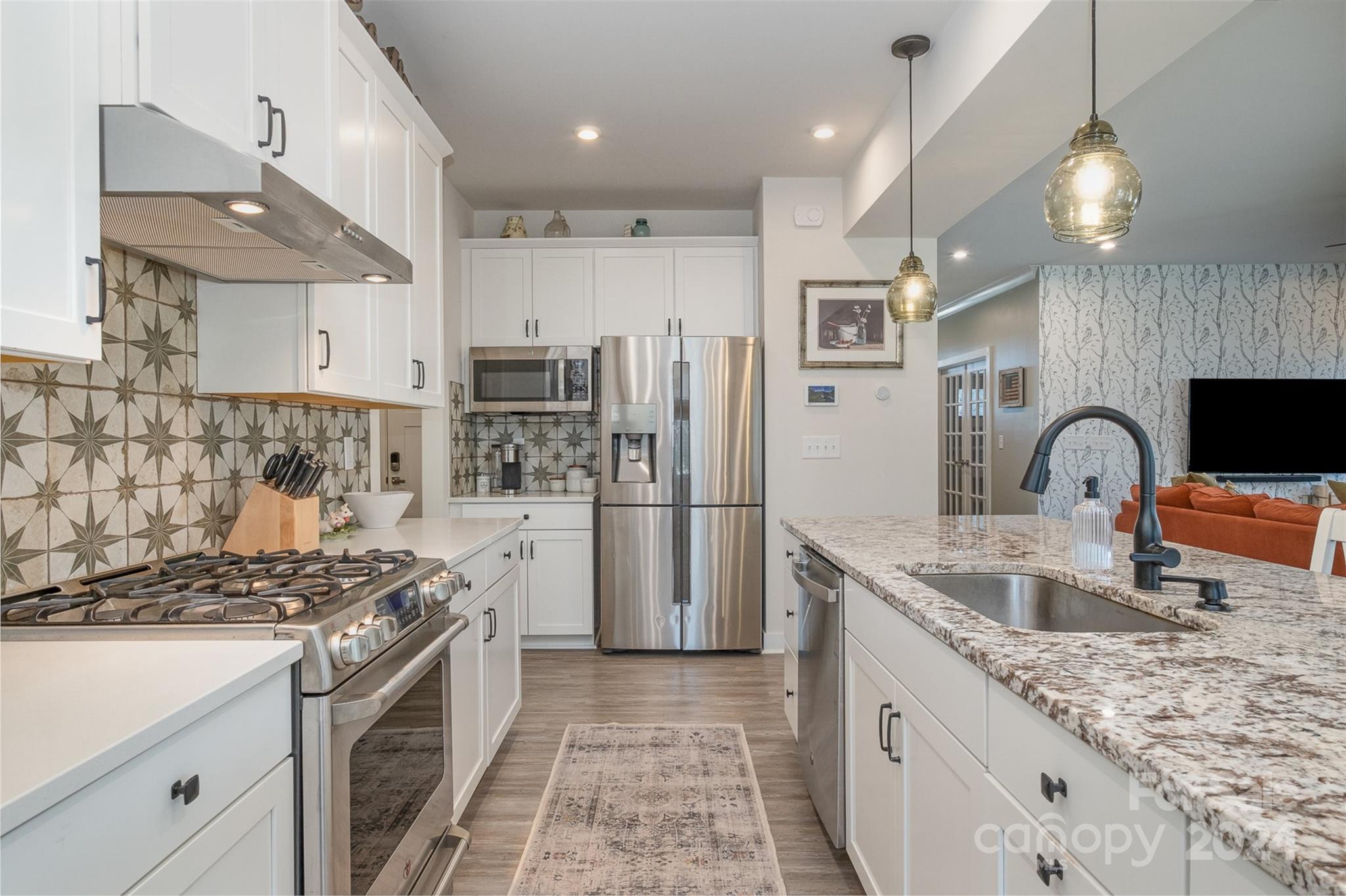 6202 Holland Street Fort Mill, SC 29707 - Photo 13 of 39 a kitchen with granite countertop a sink stainless steel appliances and cabinets