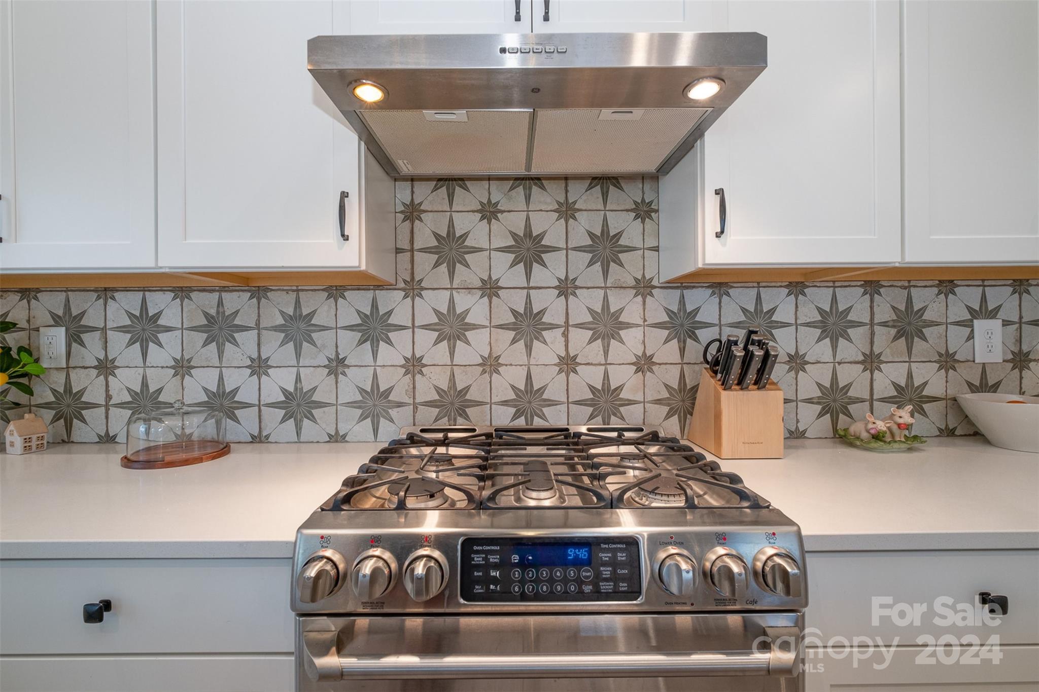 6202 Holland Street Fort Mill, SC 29707 - Photo 15 of 39 a stove sitting inside of a kitchen with white cabinets