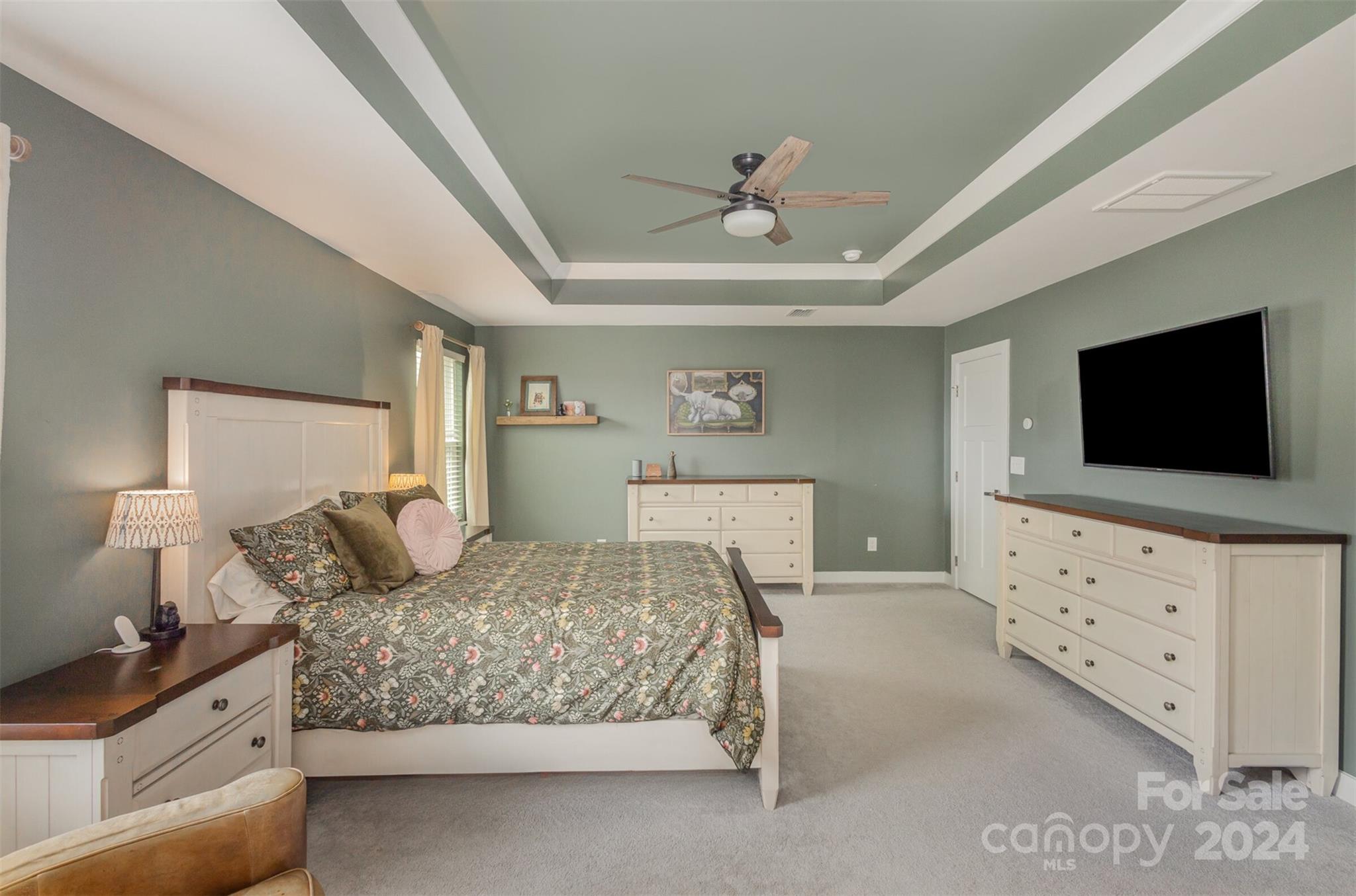 6202 Holland Street Fort Mill, SC 29707 - Photo 22 of 39 a bedroom with a bed and a flat tv screen on dresser