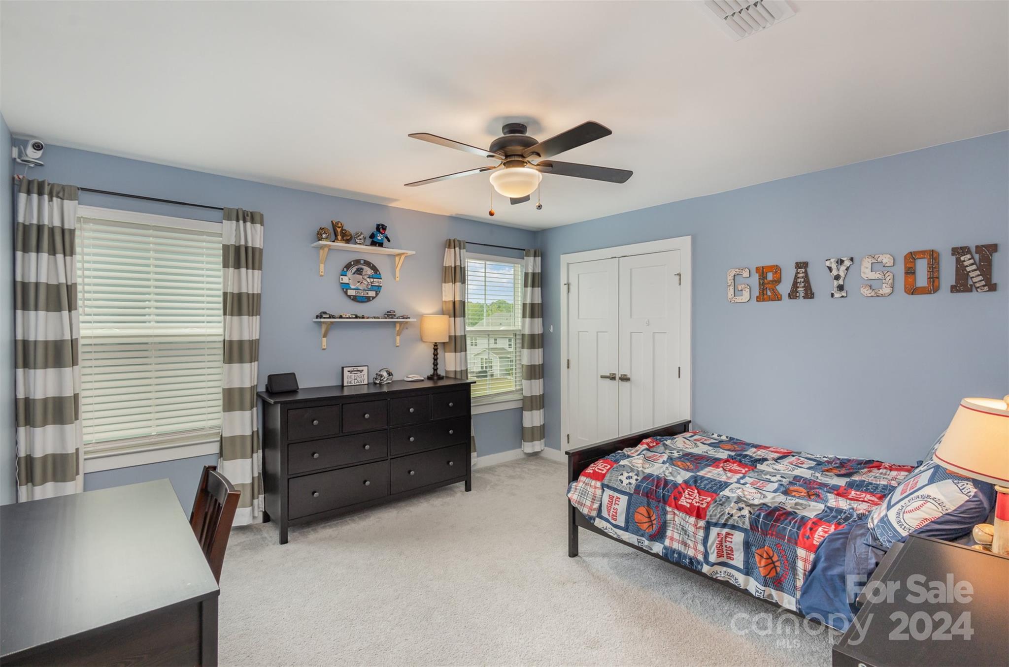 6202 Holland Street Fort Mill, SC 29707 - Photo 31 of 39 a bedroom with a bed and a chandelier