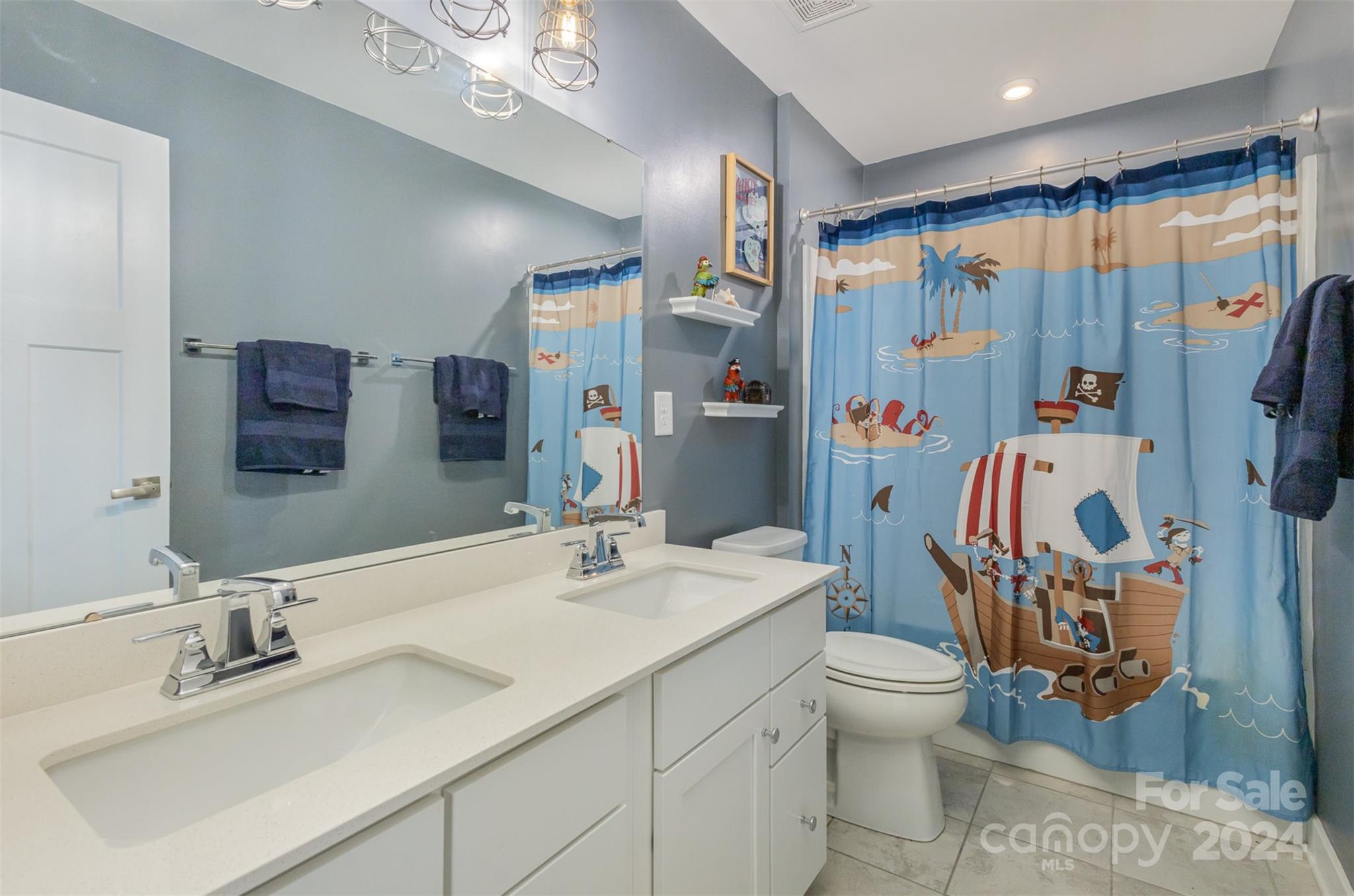 6202 Holland Street Fort Mill, SC 29707 - Photo 32 of 39 a bathroom with a sink toilet mirror vanity and shower