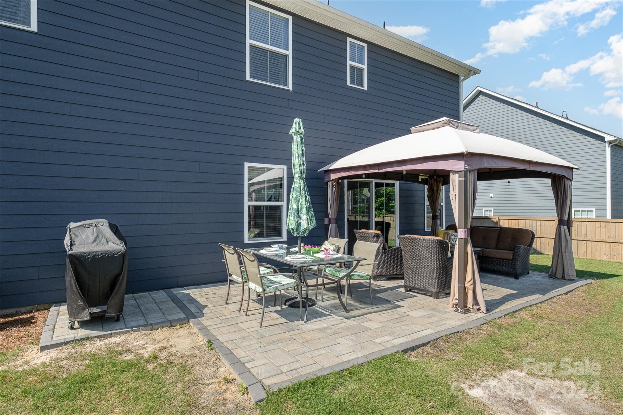 6202 Holland Street Fort Mill, SC 29707 - Photo 35 of 39 a view of a house with backyard sitting area and porch