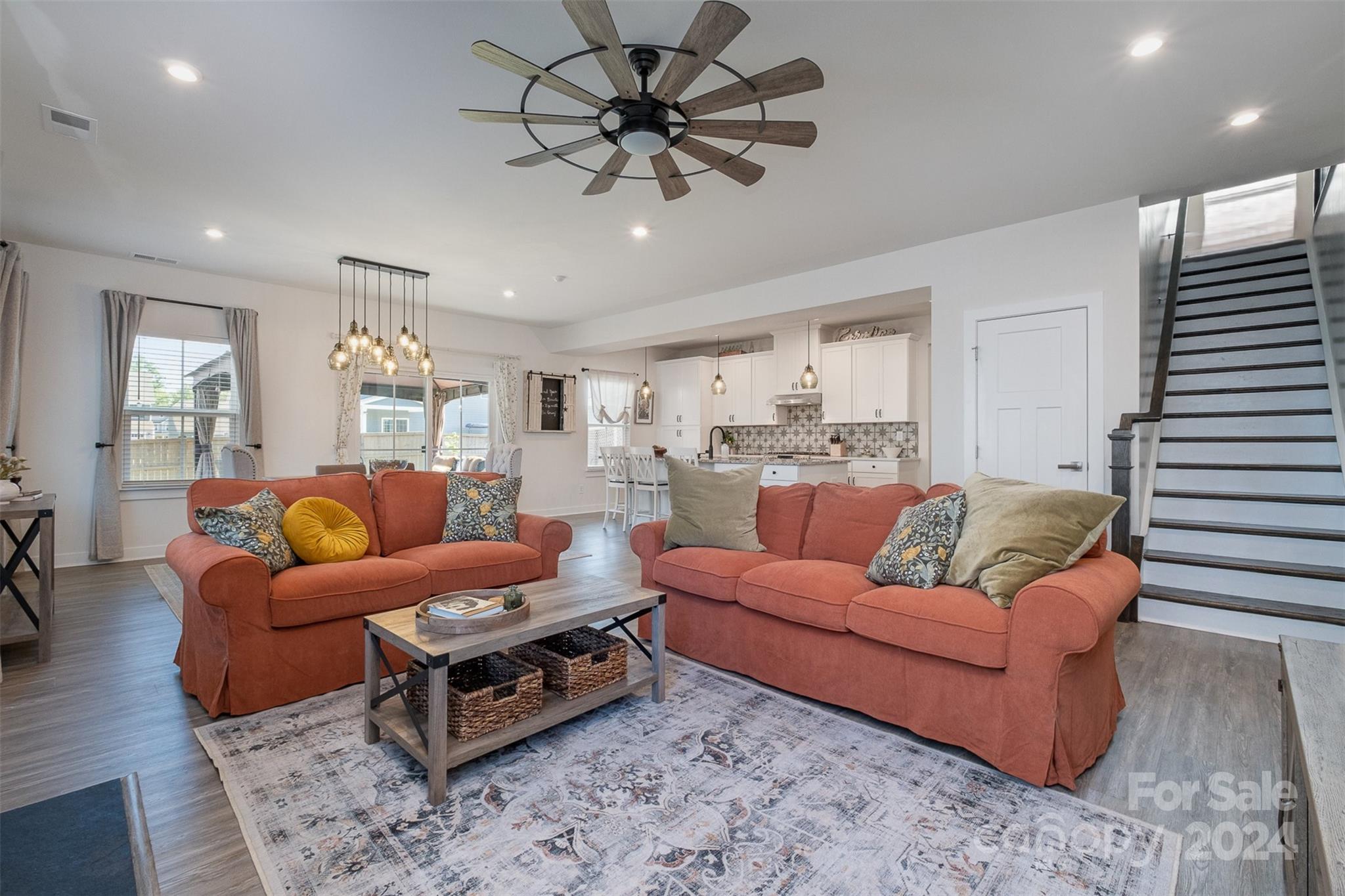 6202 Holland Street Fort Mill, SC 29707 - Photo 5 of 39 a living room with furniture a ceiling fan and a rug
