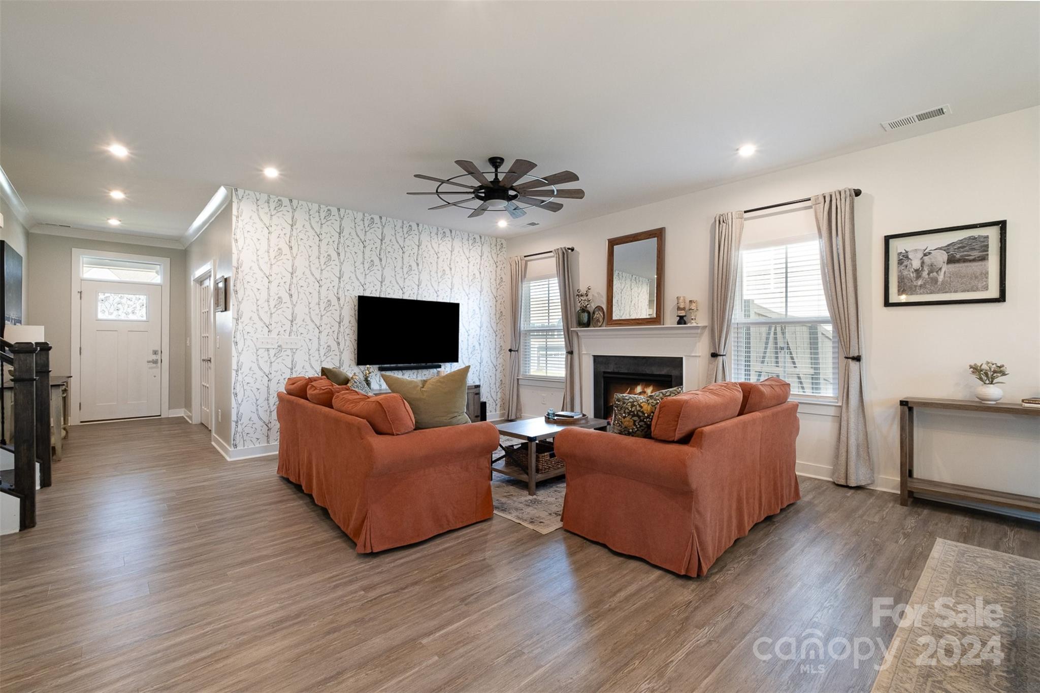 6202 Holland Street Fort Mill, SC 29707 - Photo 6 of 39 a living room with furniture a flat screen tv and a fireplace