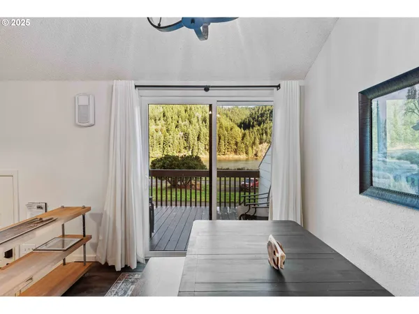 a view of a bedroom with wooden floor and a window