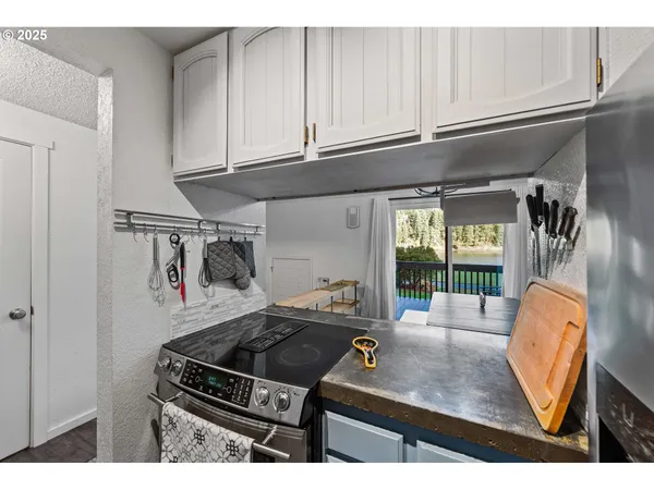 a kitchen with stainless steel appliances granite countertop a sink stove and cabinets