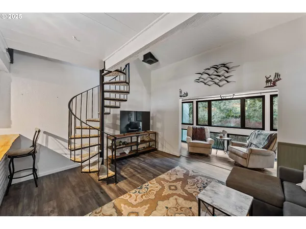 a living room with furniture a rug and a flat screen tv