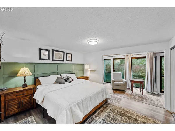 a bedroom with a large bed and a window