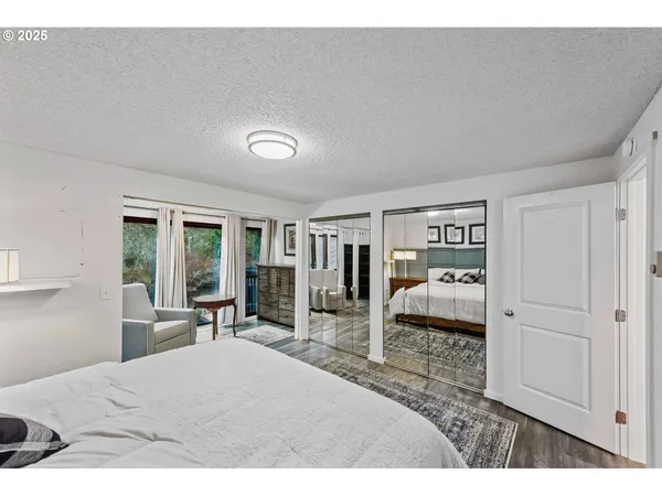 a bedroom with a bed and large window