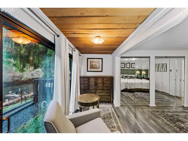 a living room with furniture and a floor to ceiling window