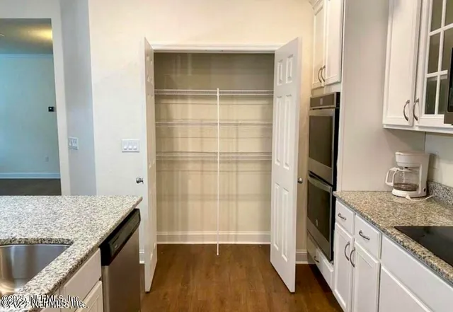 a kitchen with a refrigerator and cabinets