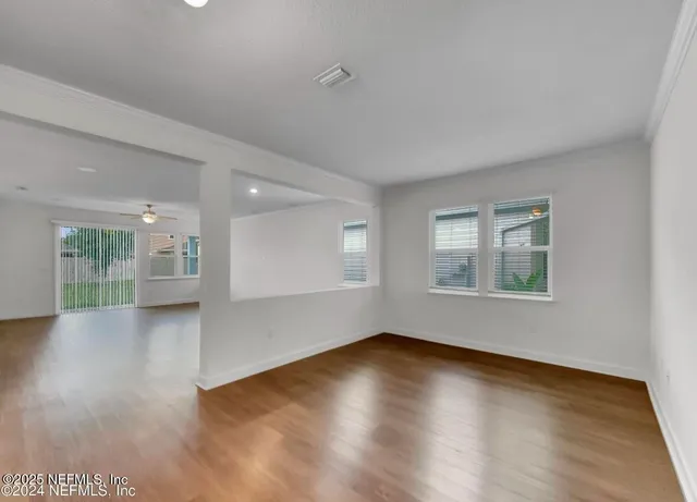 a view of a hallway with wooden floor
