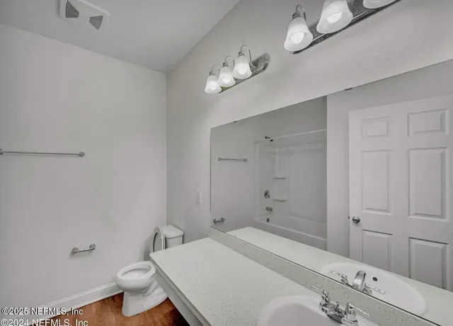 an empty room with a window and a ceiling fan