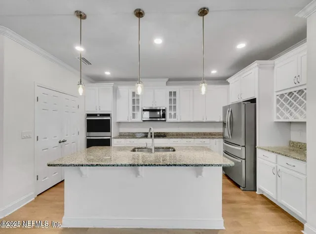 a kitchen with granite countertop a sink stove and refrigerator