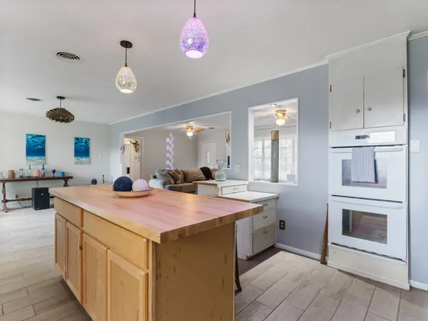 a kitchen with a stove refrigerator and cabinets