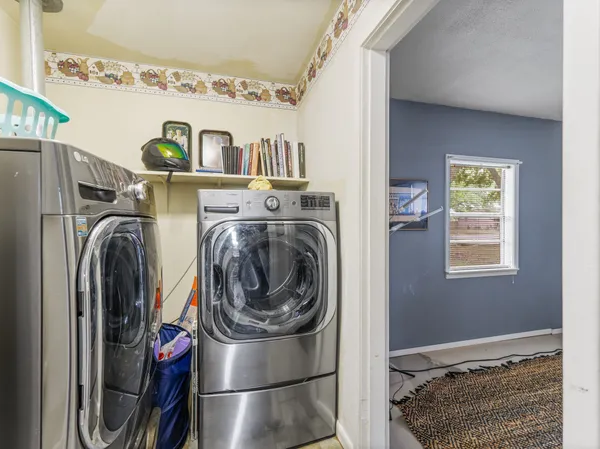 a utility room with closet dryer and washer