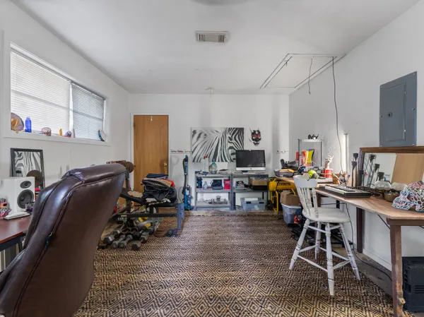 a view of a workspace with furniture and a kitchen