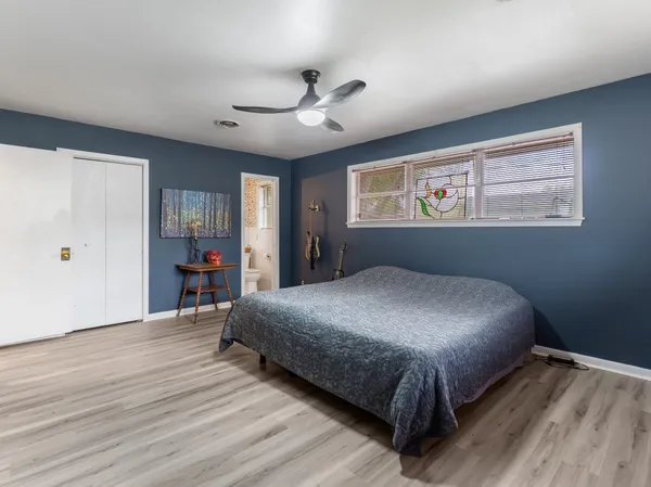 a bedroom with bed and window