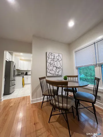a dining room with furniture and window
