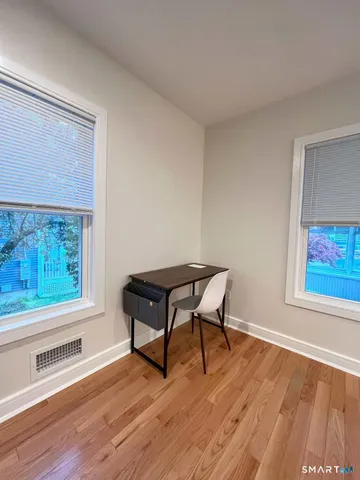 a bench sitting in a room next to a window