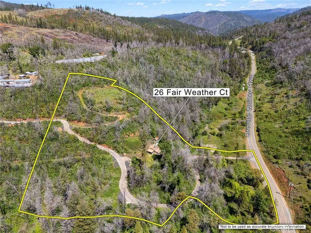 a front view of house with yard and trees around