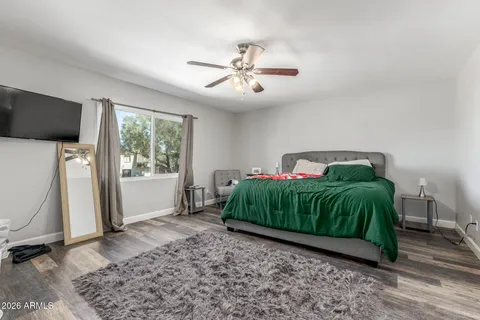 a bedroom with a bed and a flat screen tv
