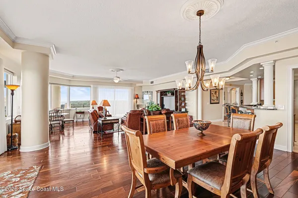 a living room with furniture kitchen view and a window