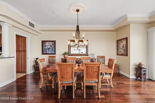 a living room with furniture kitchen view and a flat screen tv