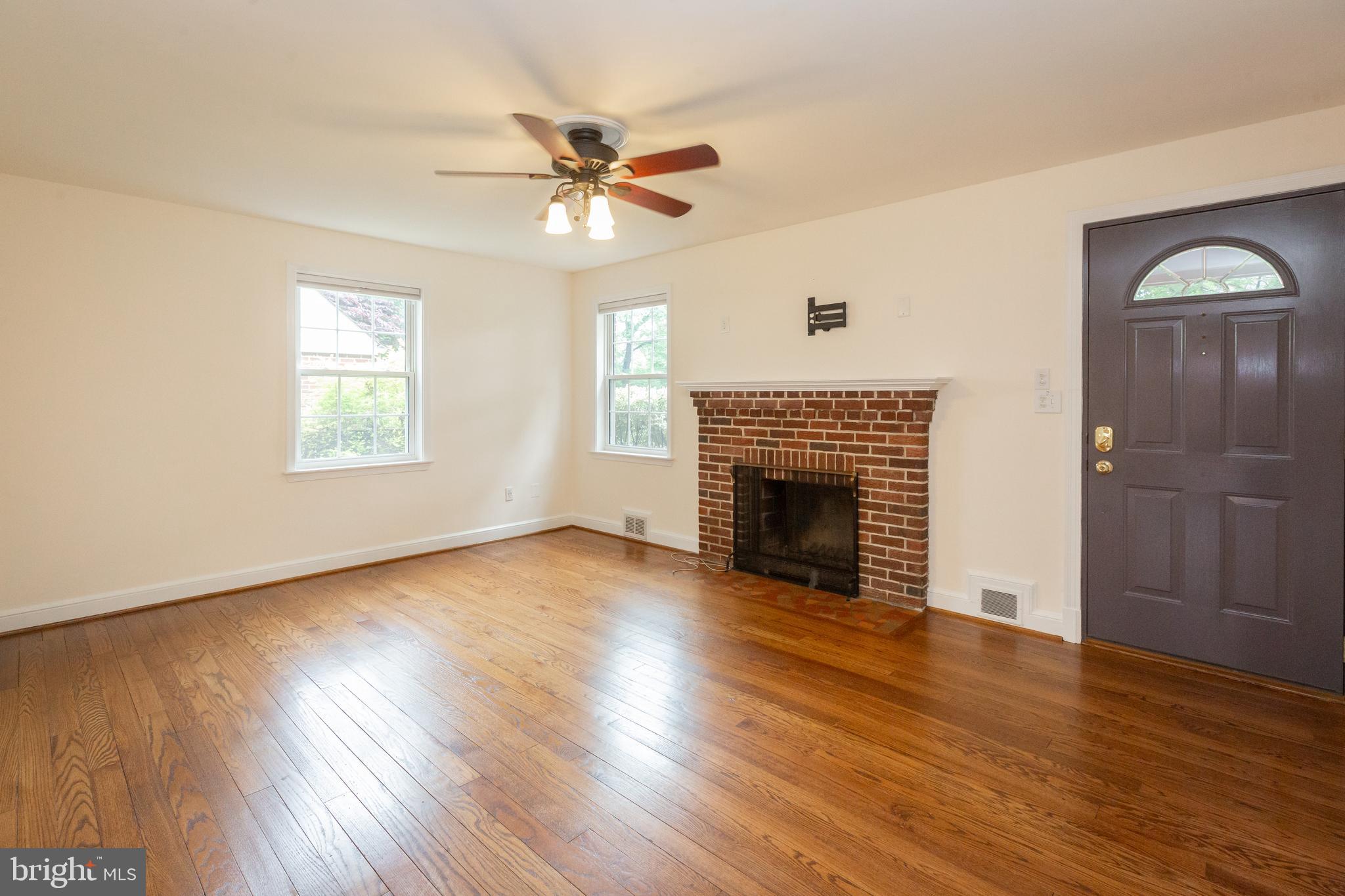 2016 Lansdowne Way Silver Spring, MD 20910 - Photo 5 of 23 a view of an empty room with wooden floor fireplace and a window
