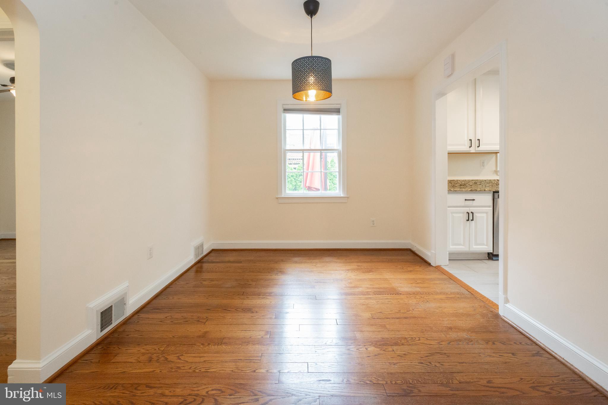 2016 Lansdowne Way Silver Spring, MD 20910 - Photo 6 of 23 an empty room with wooden floor cabinet and windows