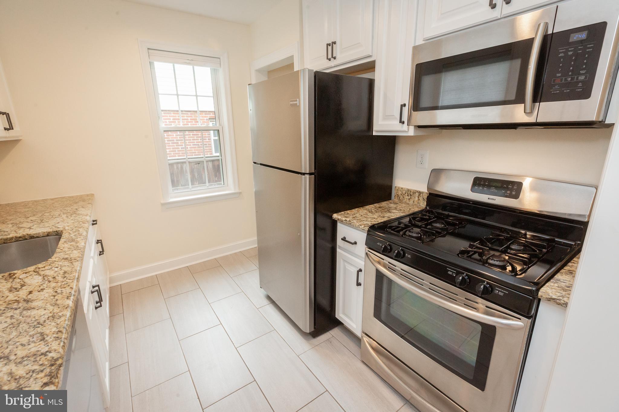 2016 Lansdowne Way Silver Spring, MD 20910 - Photo 7 of 23 a kitchen with granite countertop a stove and a microwave