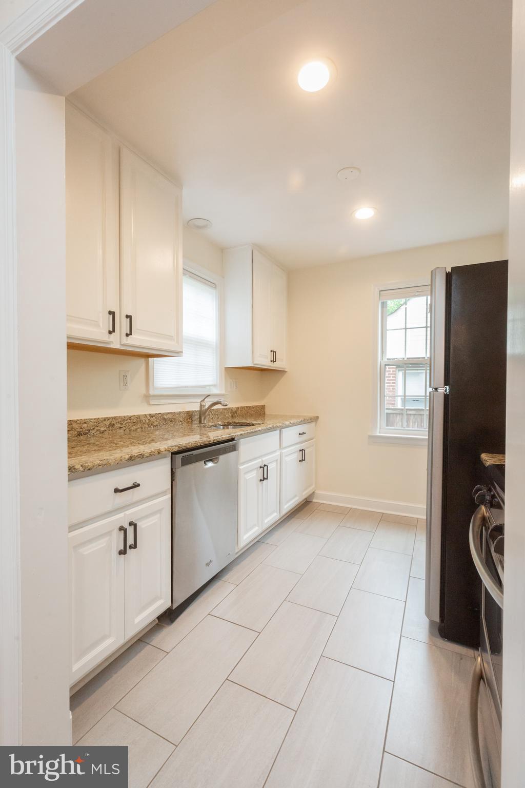 2016 Lansdowne Way Silver Spring, MD 20910 - Photo 8 of 23 a kitchen with stainless steel appliances granite countertop a stove a sink and a refrigerator