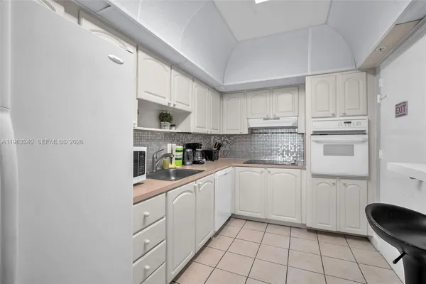 a kitchen with cabinets and appliances