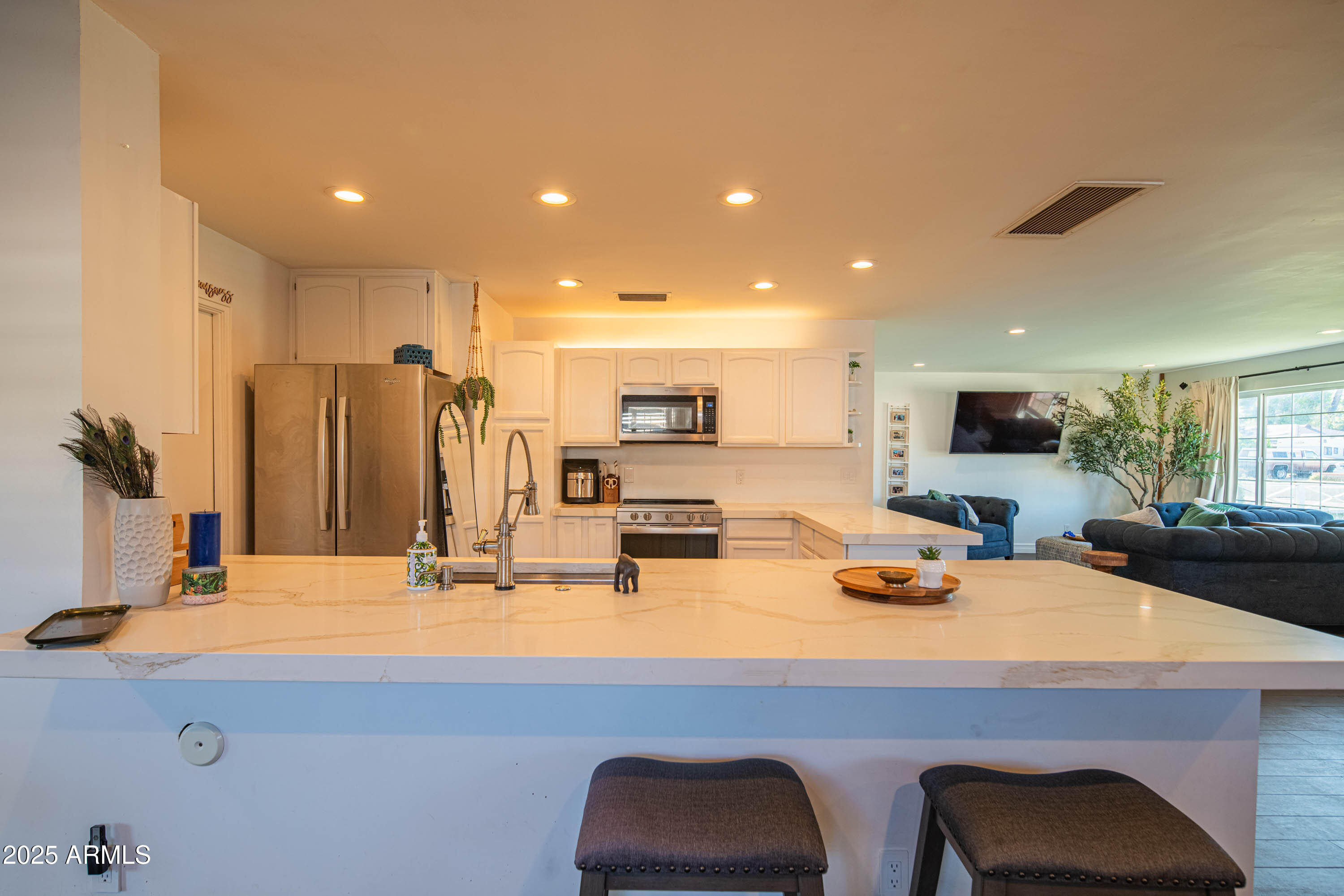 1909 East Bethany Home Road Phoenix, AZ 85016 - Photo 20 of 71 a room with stainless steel appliances kitchen island granite countertop a sink and cabinets