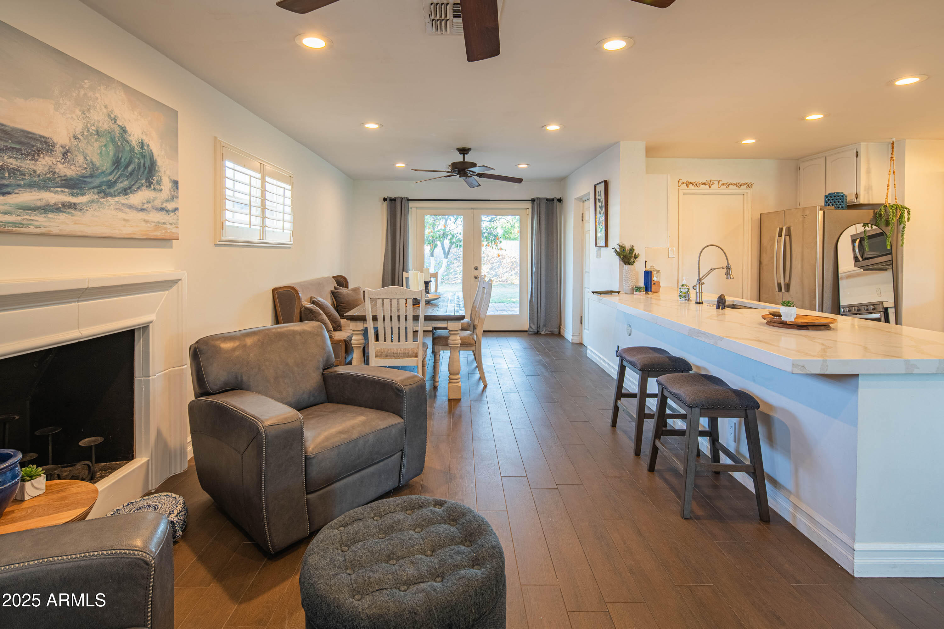 1909 East Bethany Home Road Phoenix, AZ 85016 - Photo 26 of 71 a living room with furniture a flat screen tv and kitchen view