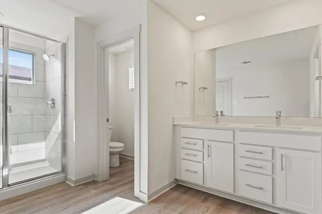 a bathroom with a granite countertop sink toilet and shower