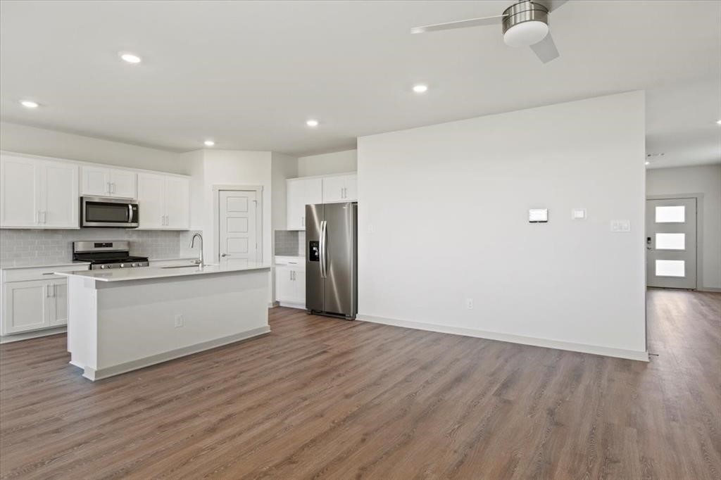 530 Wilshire Road San Marcos, TX 78666 - Photo 5 of 30 a view of kitchen with stainless steel appliances refrigerator stove microwave and cabinets
