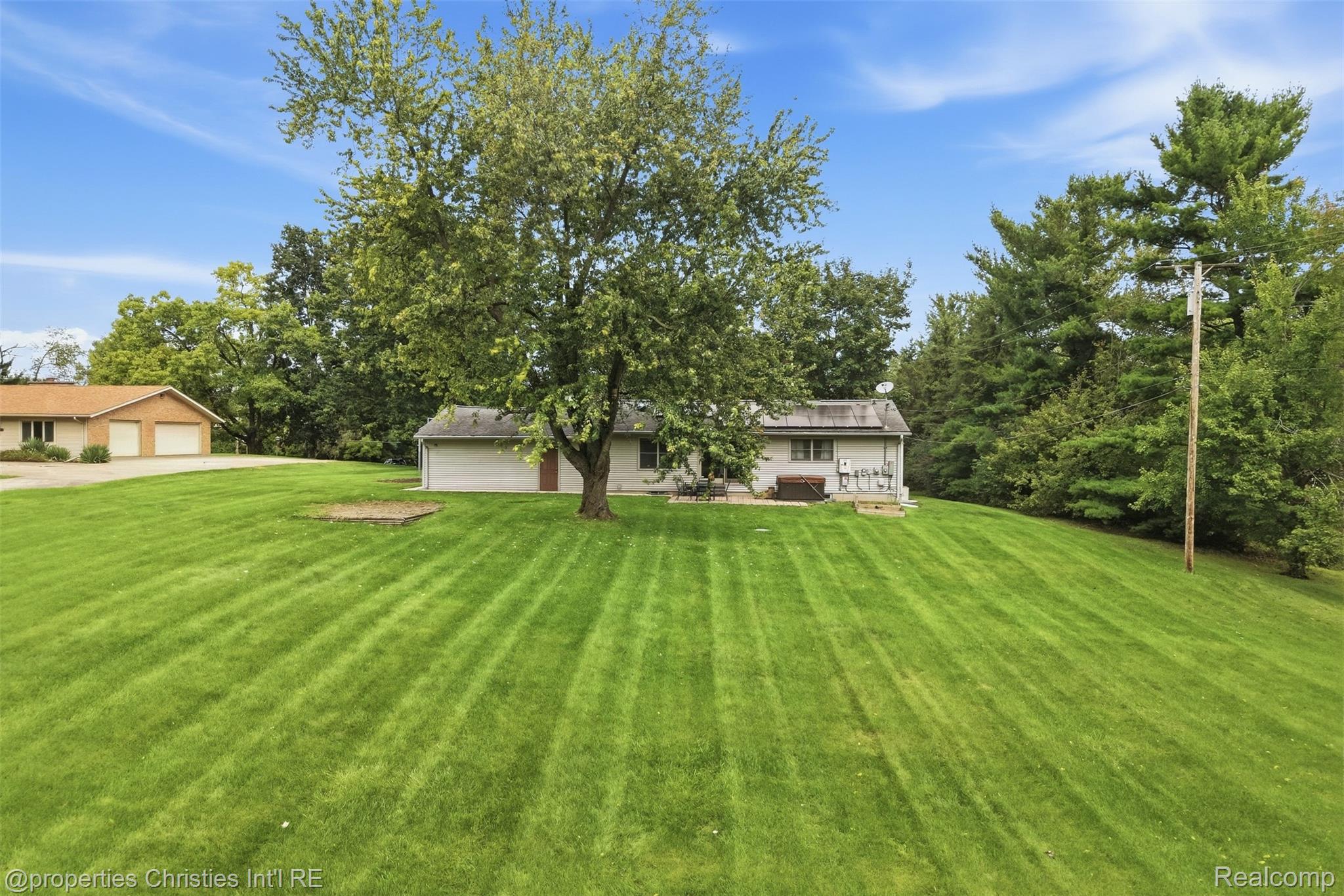 4030 Textile Road Ypsilanti, MI 48197 - Photo 54 of 58 Expansive green lawn with mature trees and a single-story residence