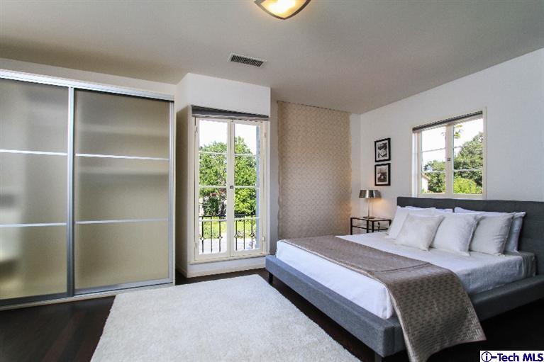 386 South Meridith Avenue Pasadena, CA 91106 - Photo 14 of 28 a bedroom with a balcony a bed and a window