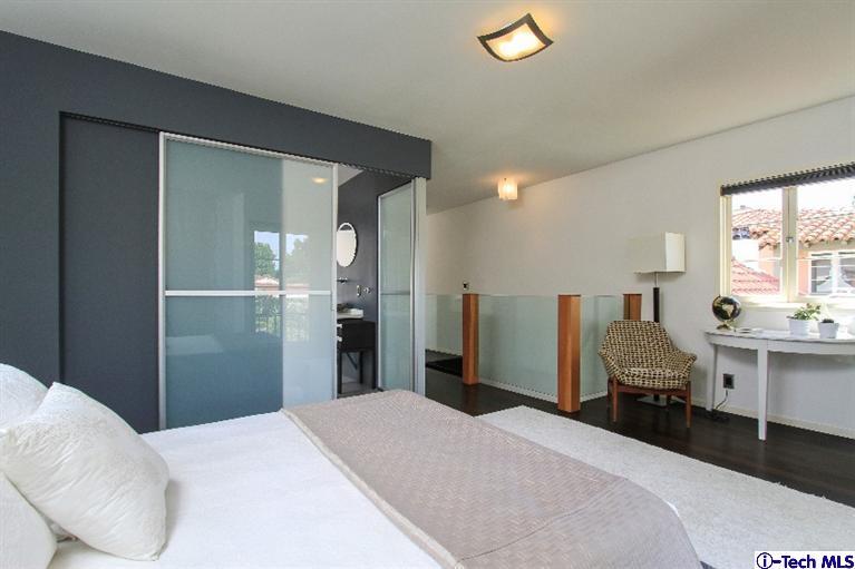 386 South Meridith Avenue Pasadena, CA 91106 - Photo 15 of 28 a bedroom with a bed and a lamp