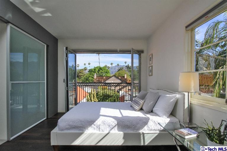 386 South Meridith Avenue Pasadena, CA 91106 - Photo 20 of 28 a bedroom with a bed and glass window