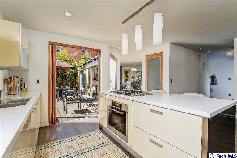 386 South Meridith Avenue Pasadena, CA 91106 - Photo 10 of 28 a kitchen with a stove a sink and a refrigerator