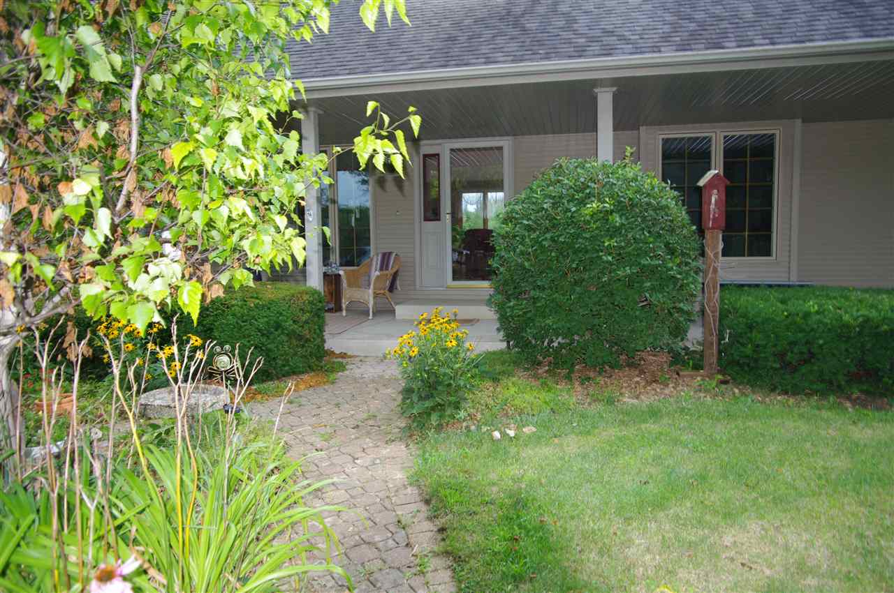 8407 North Kilbuck Road Monroe Center, IL 61052 - Photo 1 of 20 a front view of a house with a yard