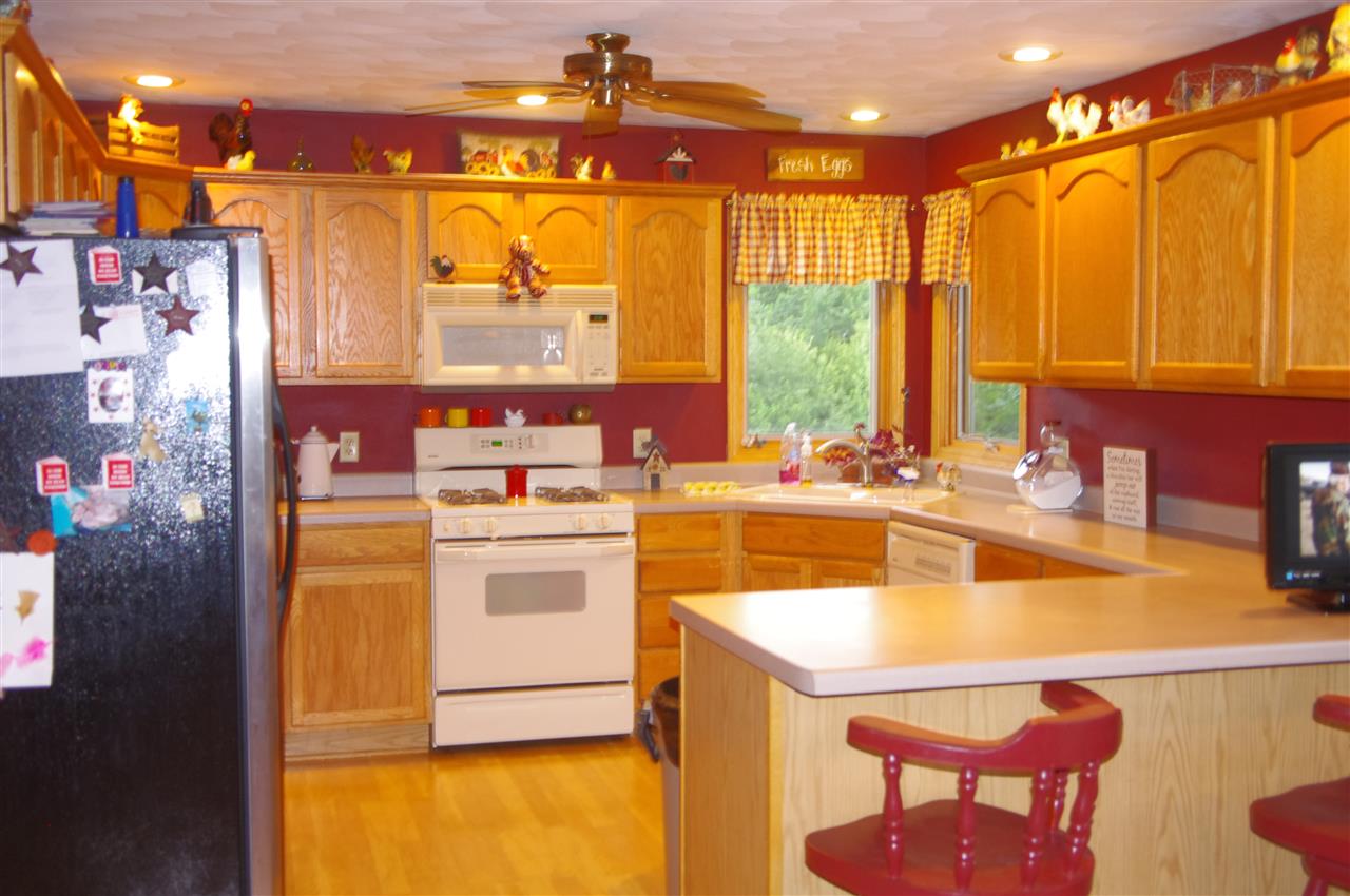 8407 North Kilbuck Road Monroe Center, IL 61052 - Photo 12 of 20 a kitchen with a sink a stove and a refrigerator