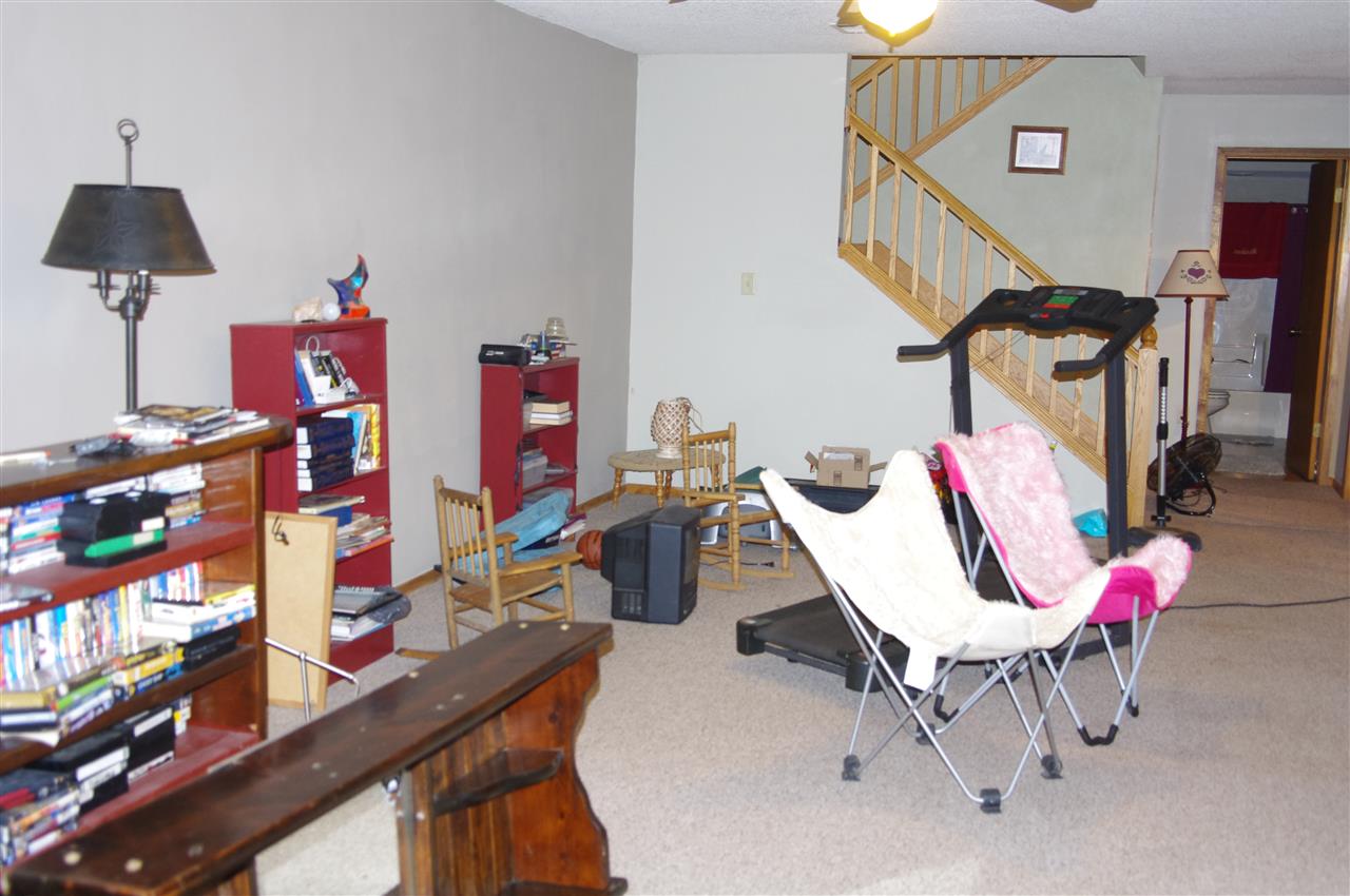 8407 North Kilbuck Road Monroe Center, IL 61052 - Photo 16 of 20 a bedroom with furniture and a book shelf